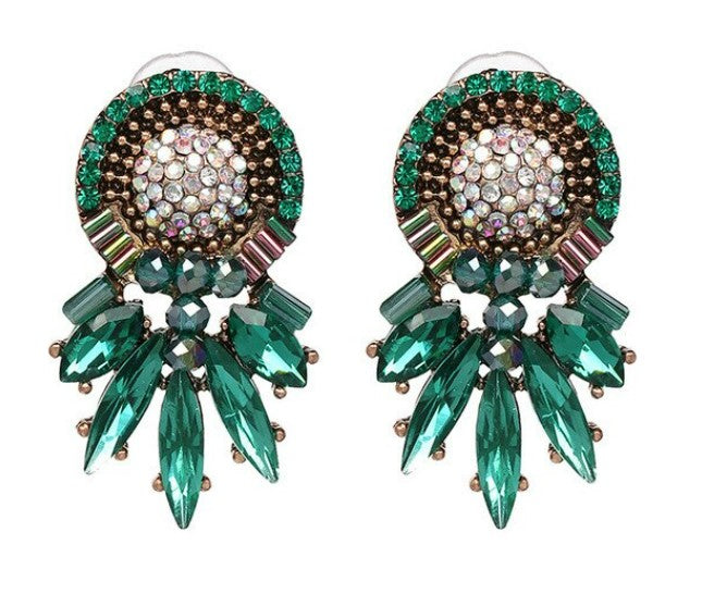 Crafted with sophisticated green tones, these statement studs bring a timeless elegance to any outfit.