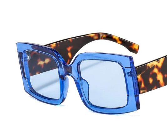 Have some fun with our blue leopard oversized square statement sunglasses. Lightweight and totally on trend!   Sunglasses are onesize and come with an Entire Me carry case.  Frame: Polycarbonate  Lense Optical: Photochromic, Anti-reflective, UV400