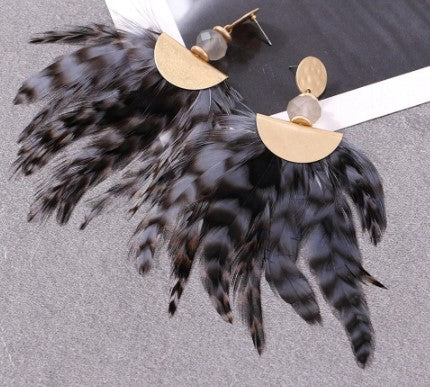 Hope is your go to retro elegant feather statement earrings. With a gold alloy dangle, securing to a bead for that added wow.
