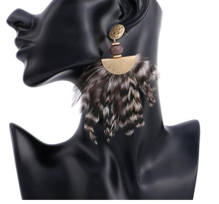 Hope is your go to retro elegant feather statement earrings. With a gold alloy dangle, securing to a bead for that added wow.