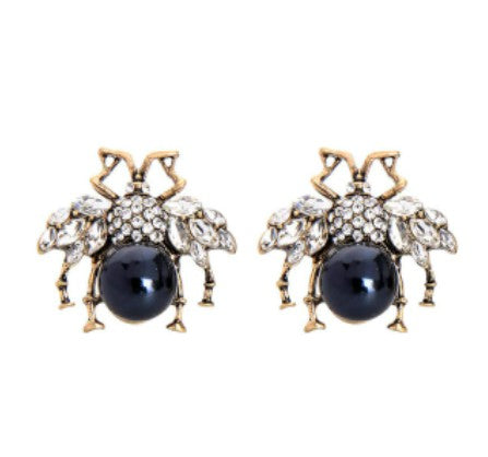 A large bug stud with a dark grey faux pearl body, crystal encrusted wings and vintage gold framing. The detailing on these large bugs is just gorgeous.