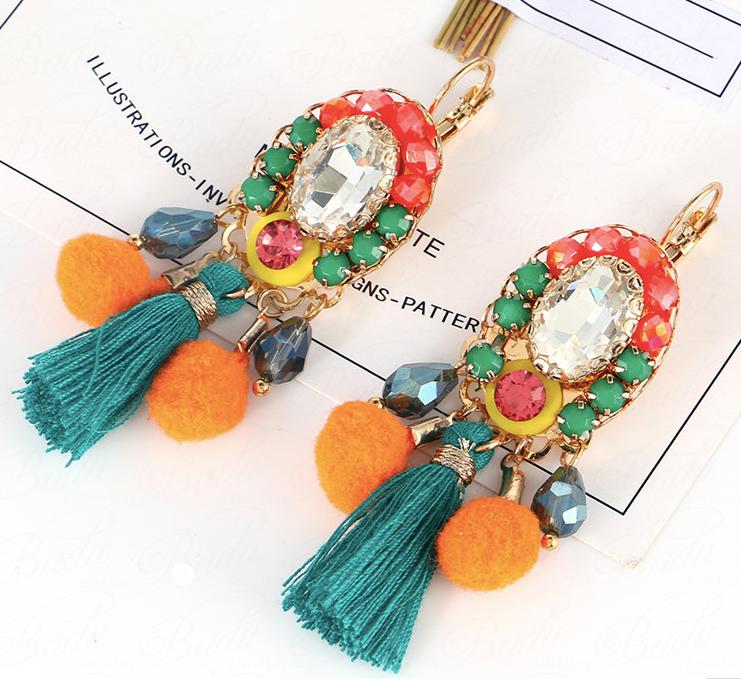 These Mini Mexicana Earrings are a vivid and eye-catching accessory. They feature colorful pom poms and crystal gems atop small resin studs and a larger clear crystal, all framed by a miniature tassel. Lightweight and easy to wear, these earrings arrive in our Entire Me pouch for luxurious presentation.