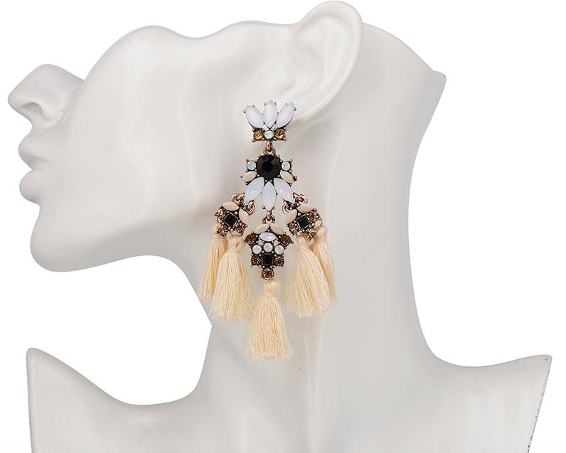 A medium sized flower petal pendant in tassels of three, complimented with matching coloured crystals and resin petals and a contrasting stone in the centre. 