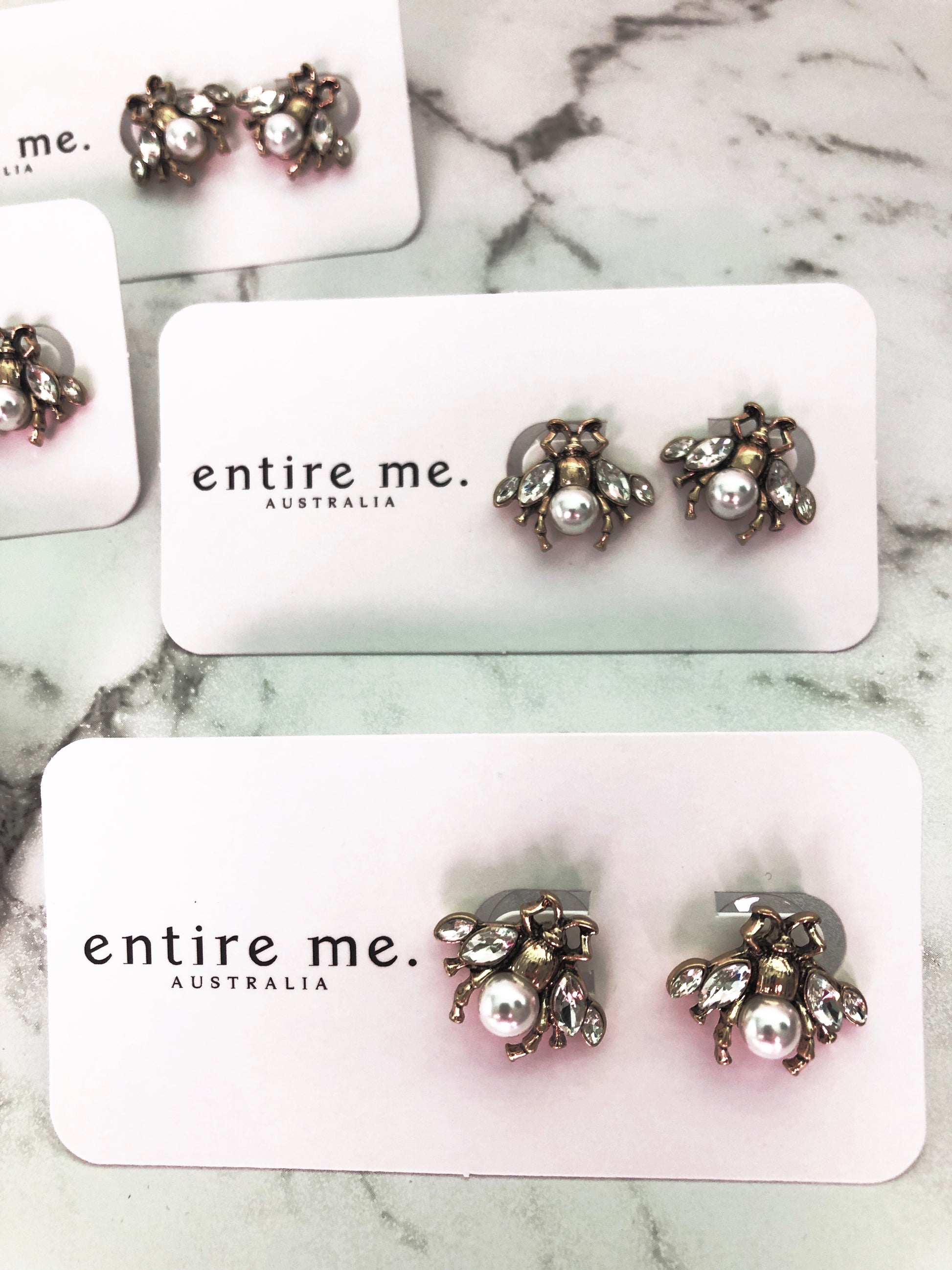 A small and intricate bug stud earring in vintage gold, faux pearl and clear crystals. The detailing on the little bug is just gorgeous. 