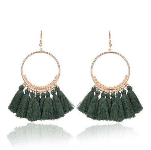 A bold colour cotton tassel earring on a very lightweight gold circular detailed frame. Versatile and easy wearing.
