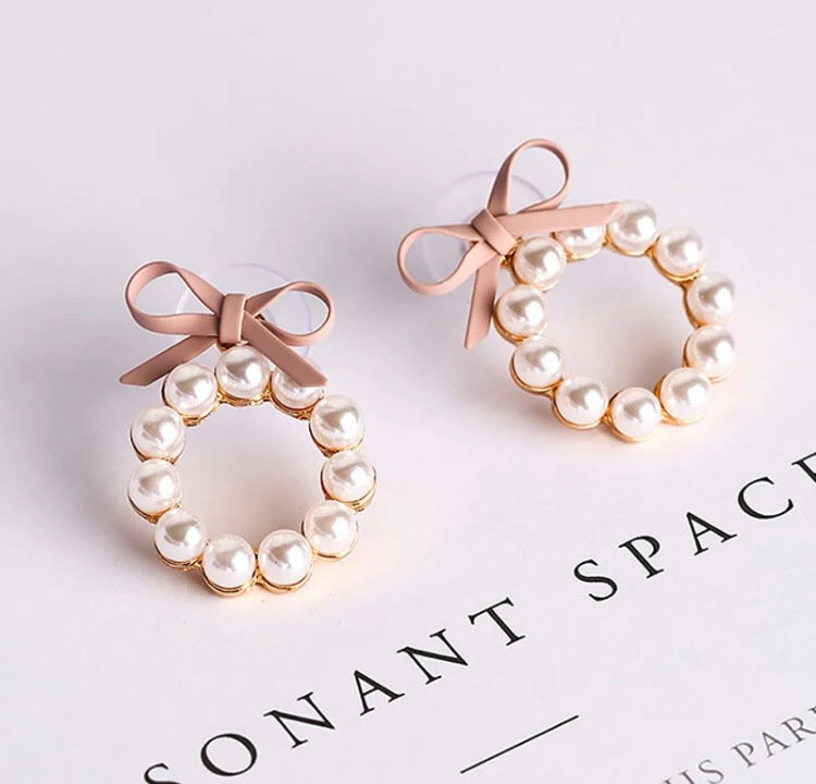 A gorgeous hoop of pearls held on with a faux leather bow.   The pearl hoop is detachable so you can also wear the bows as studs on their own!  And if you are so inclined, you can wear these beauties with the pearl hoop at the back of your lobe as well.