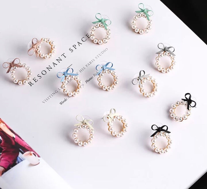 A gorgeous hoop of pearls held on with a faux leather bow.   The pearl hoop is detachable so you can also wear the bows as studs on their own!  And if you are so inclined, you can wear these beauties with the pearl hoop at the back of your lobe as well.