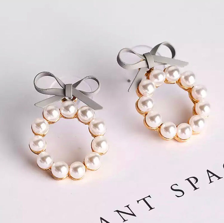A gorgeous hoop of pearls held on with a faux leather bow.   The pearl hoop is detachable so you can also wear the bows as studs on their own!  And if you are so inclined, you can wear these beauties with the pearl hoop at the back of your lobe as well.