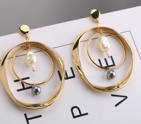 A double gold hoop with white and black pearl detailing.  