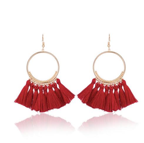 A bold colour cotton tassel earring on a very lightweight gold circular detailed frame. Versatile and easy wearing.
