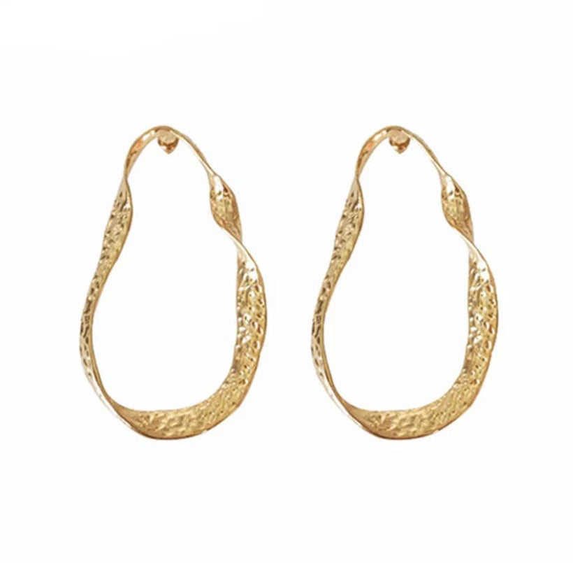 A twisted oblong oversized hoop in gold or silver.