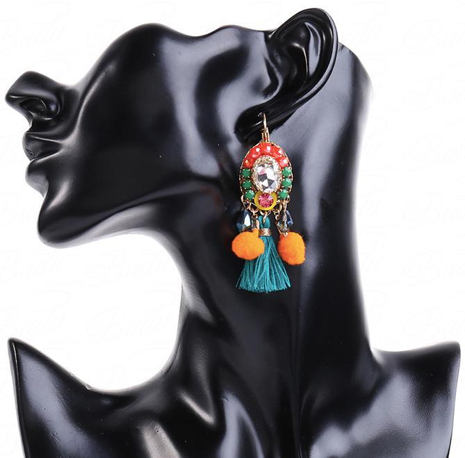These Mini Mexicana Earrings are a vivid and eye-catching accessory. They feature colorful pom poms and crystal gems atop small resin studs and a larger clear crystal, all framed by a miniature tassel. Lightweight and easy to wear, these earrings arrive in our Entire Me pouch for luxurious presentation.