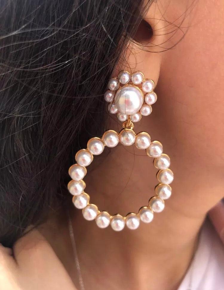 A simple yet beautiful pearl circular drop with a flower shaped stud. A true statement style and very versatile. Lightweight.