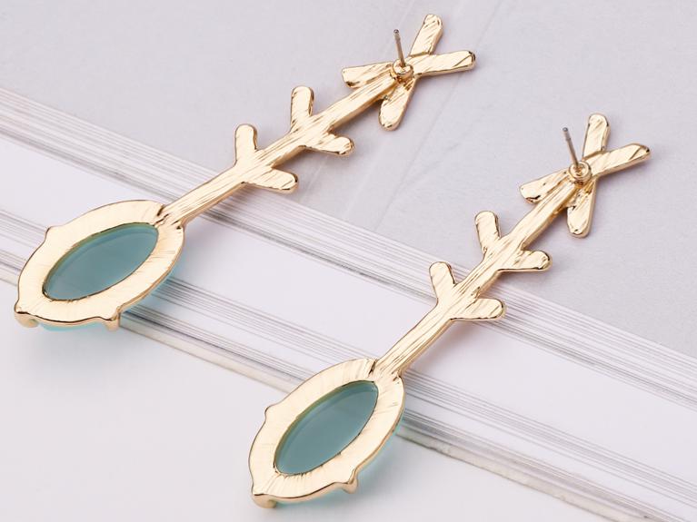 An oval resin drop in a gorgeous green attached to a golden cross arrow design.  Simple and classy.