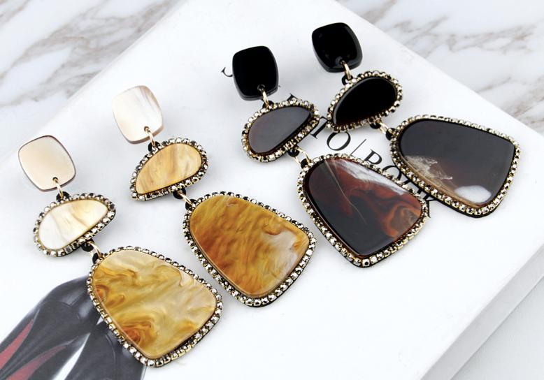 A three piece design made from marbled acrylic board in a golden coloured frame and bordered by tiny cubic zirconias.  Each earring is cut from a single piece of acrylic board, meaning each earring is unique and different.  Like you.