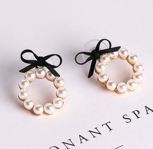 A gorgeous hoop of pearls held on with a faux leather bow.   The pearl hoop is detachable so you can also wear the bows as studs on their own!  And if you are so inclined, you can wear these beauties with the pearl hoop at the back of your lobe as well.