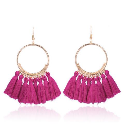 A bold colour cotton tassel earring on a very lightweight gold circular detailed frame. Versatile and easy wearing.