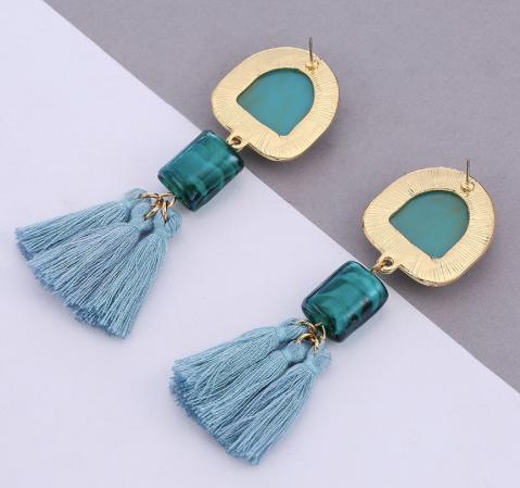 An understated alternative to simple tassels.  This jade coloured tassel and gem design is attached to a bigger similar coloured stone stud bordered in gold.  This colour looks great with red.