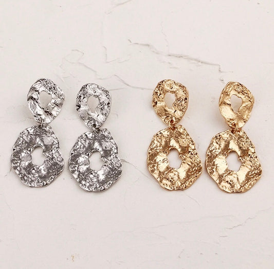 A pressed gold/silver abstract oval design. Lightweight. Versatile. Statement.