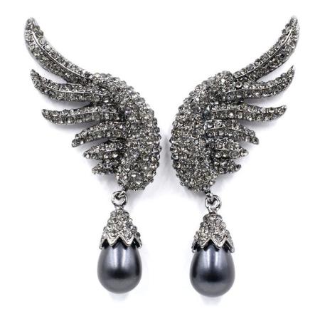 A beautiful crystal encrusted wing design complimented by a simple simulated pearl drop.  The crystal coated wings contour up the ear. They are very unique and an absolutely standout design.  Lightweight enough to wear all night.