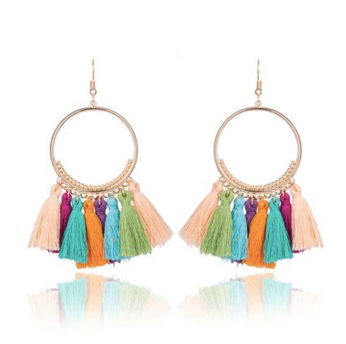 A bold colour cotton tassel earring on a very lightweight gold circular detailed frame. Versatile and easy wearing.