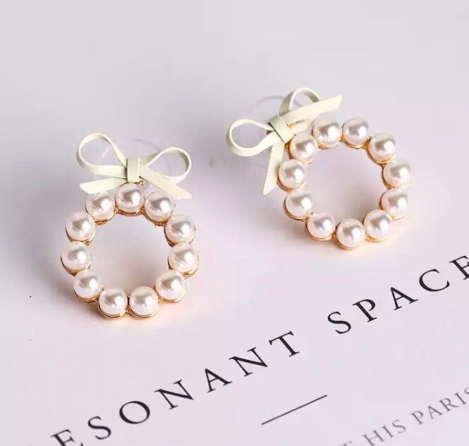 A gorgeous hoop of pearls held on with a faux leather bow.   The pearl hoop is detachable so you can also wear the bows as studs on their own!  And if you are so inclined, you can wear these beauties with the pearl hoop at the back of your lobe as well.
