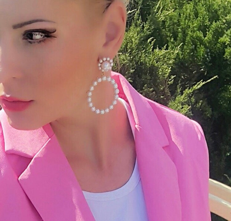 A simple yet beautiful pearl circular drop with a flower shaped stud. A true statement style and very versatile. Lightweight.