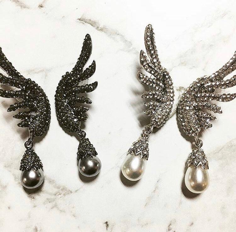 A beautiful crystal encrusted wing design complimented by a simple simulated pearl drop.  The crystal coated wings contour up the ear. They are very unique and an absolutely standout design.  Lightweight enough to wear all night.