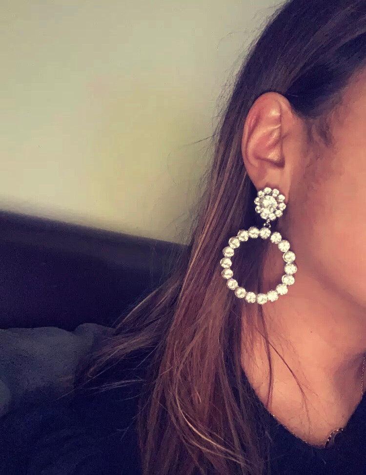A simple yet beautiful crystal circular drop with a flower shaped stud. A true statement style and very versatile. Lightweight.