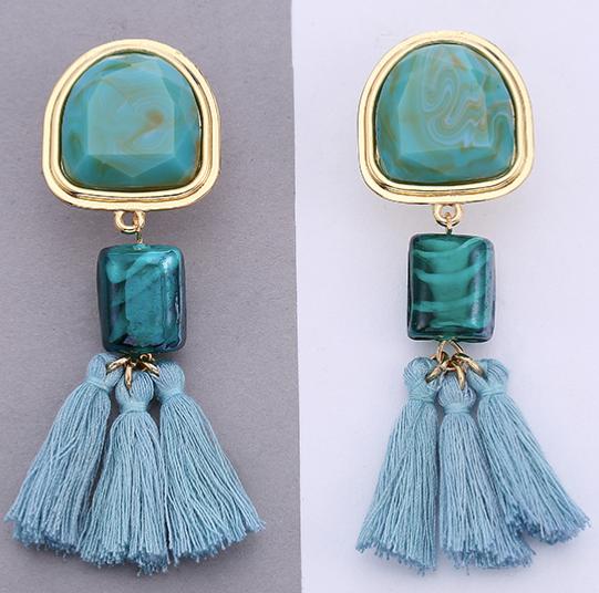 An understated alternative to simple tassels.  This jade coloured tassel and gem design is attached to a bigger similar coloured stone stud bordered in gold.  This colour looks great with red.