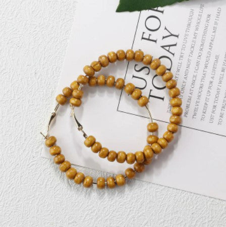 Our oversized hoop earrings with natural timber beads will not disappoint. 
