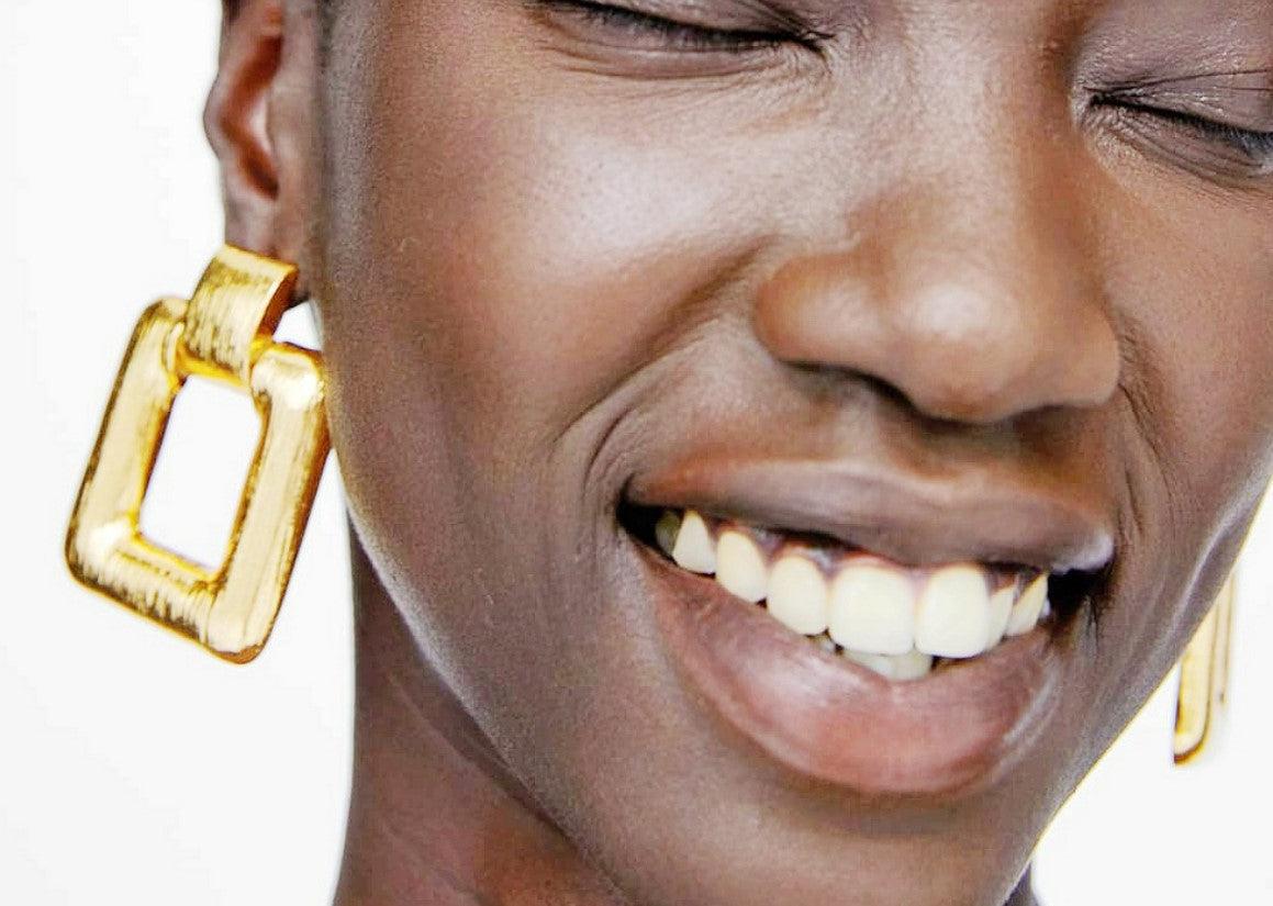 A simple large square drop earring, in either gold or silver, guaranteed to be spoken about.