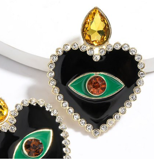 The heart shape is encrusted with rhinestones for a luxurious, bohemian look.