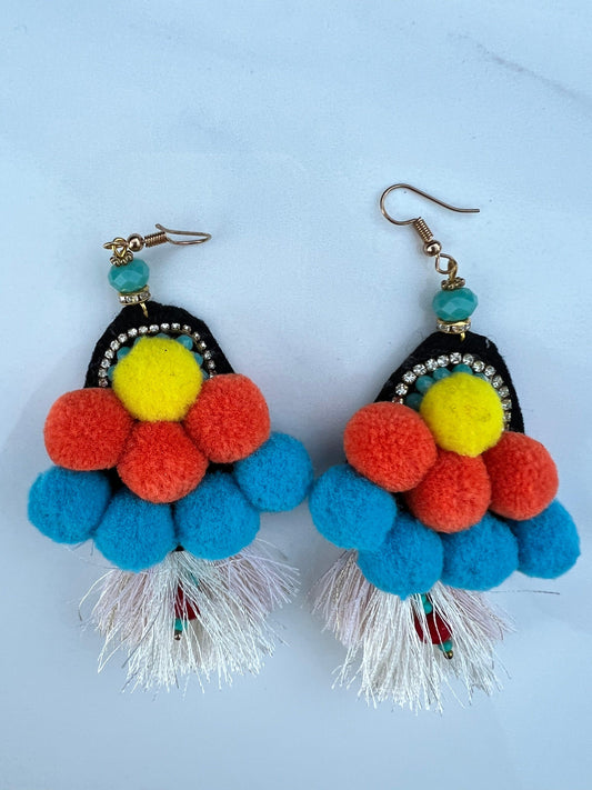 Pom poms, tassels and crystal's all wrapped into one earring!  Vibrant yellows, blues and oranges.    As these are handmade, imperfections could be expected, a true statement