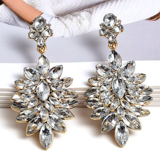 A beautiful placement of White Crystal Earrings in a Gorgeous Flower-Shaped Pure White Crystal Earrings  ~Very pretty on and one of our absolute favorite styles.   All earrings arrive beautifully packaged in our luxurious Entire Me pouch.    