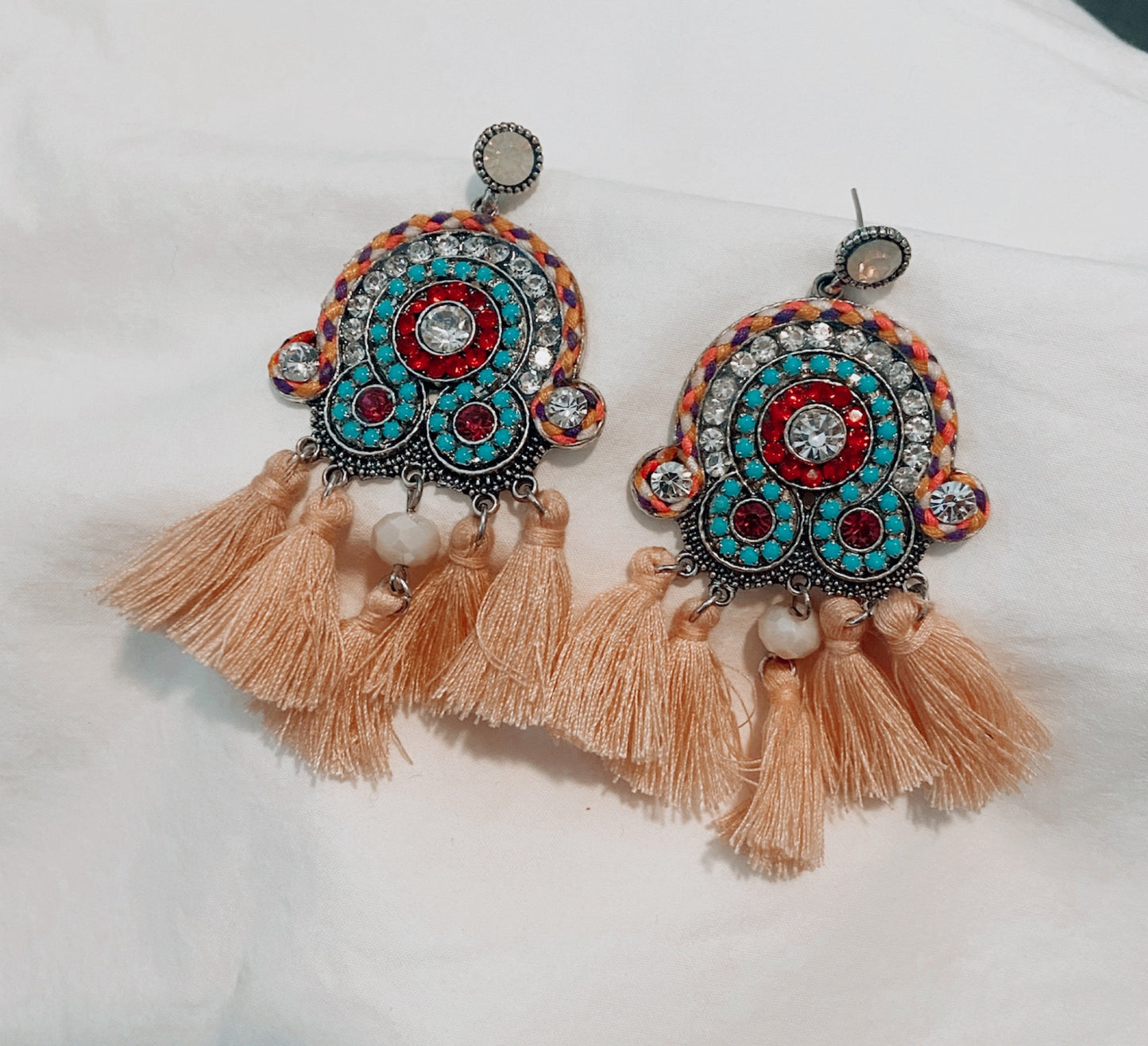 These earrings feature brightly coloured blue, red and purple crystals with peach toned tassels.  A gorgeous ethnic design with a vintage feel.    